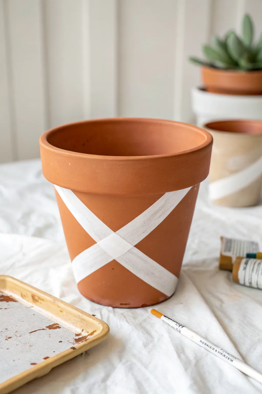 Tape makes perfect stripes, transform a simple pot with crisp lines and minimal boho charm.
