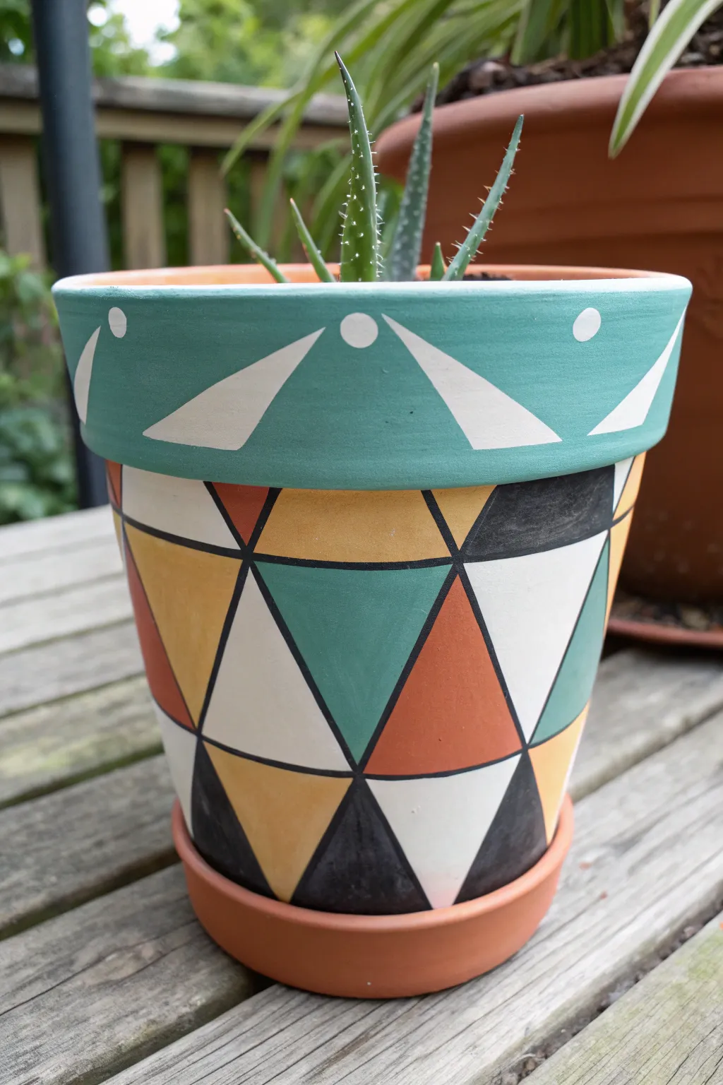 Crisp tape-style triangles and blocks turn a simple pot into a bold, minimalist statement.
