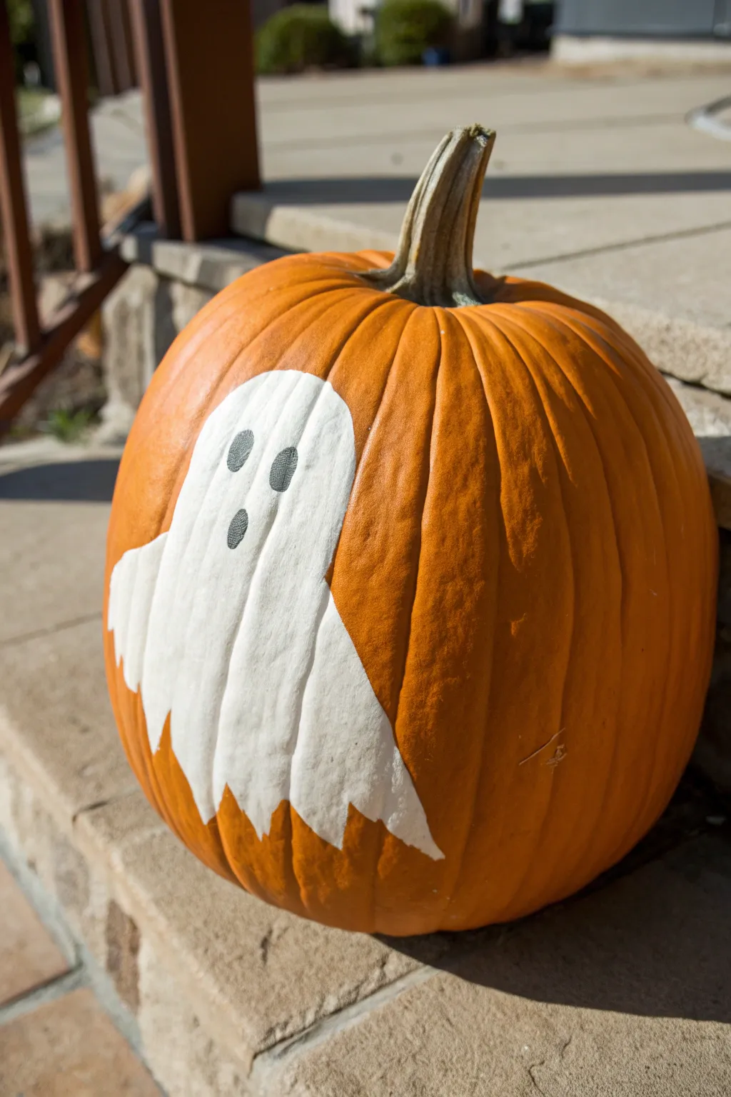 Minimalist pumpkin with a drifting white sheet ghost silhouette, crisp contrast and handmade charm