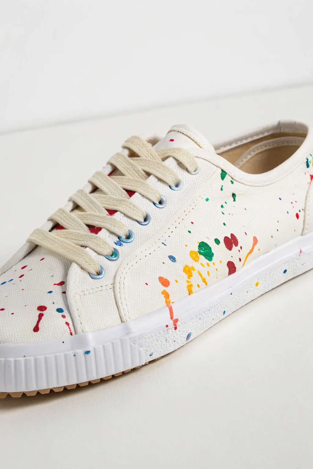 Clean sole line meets bold splatter, minimalist sneaker art with crisp masking tape edges