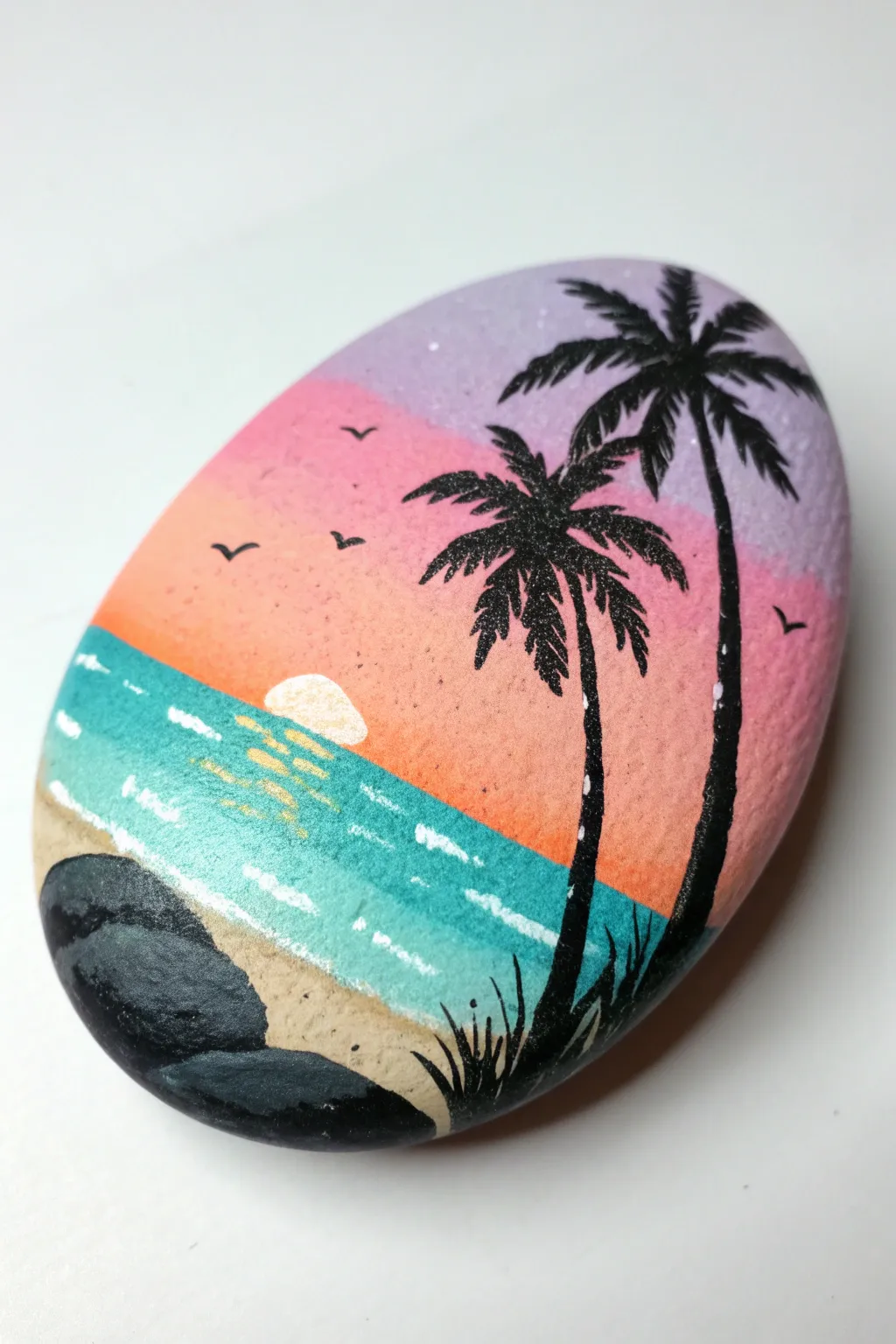 Ocean sunset palm silhouettes on a smooth painted stone, minimalist boho vibe and bold contrast
