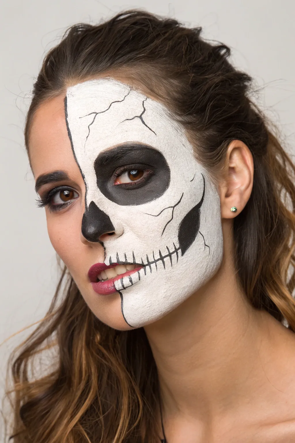 Half-skull face paint that keeps your mouth free so you can talk and snack all night.