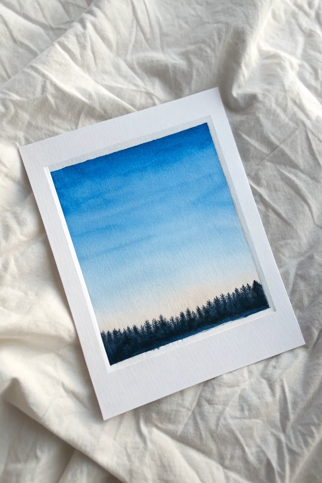 Clear blue sky gradient with a tiny treeline silhouette, calm Scandinavian minimal with handmade charm.