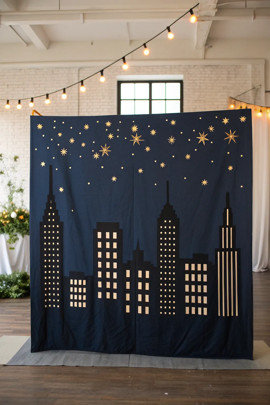 Night city skyline silhouette backdrop in deep navy with warm window lights and soft spotlights