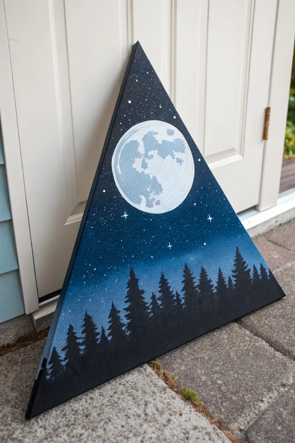 Moonlit triangle canvas: bright full moon over dark pine silhouette with tiny stars above.