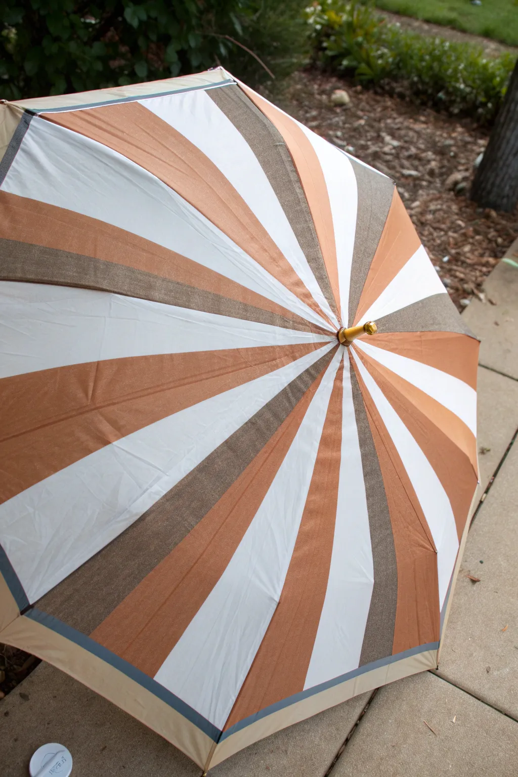 Crisp taped stripes on an umbrella, captured top-down with a satisfying fresh-peel reveal.