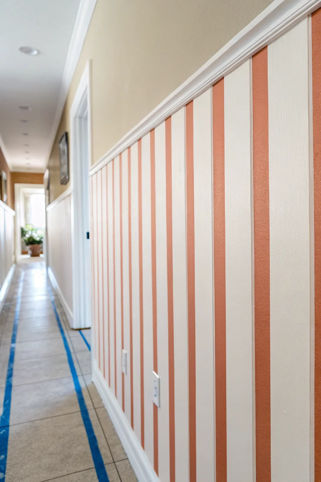 Classic stripes, crisp tape lines: a minimalist two-tone wall painting idea with big hallway impact.