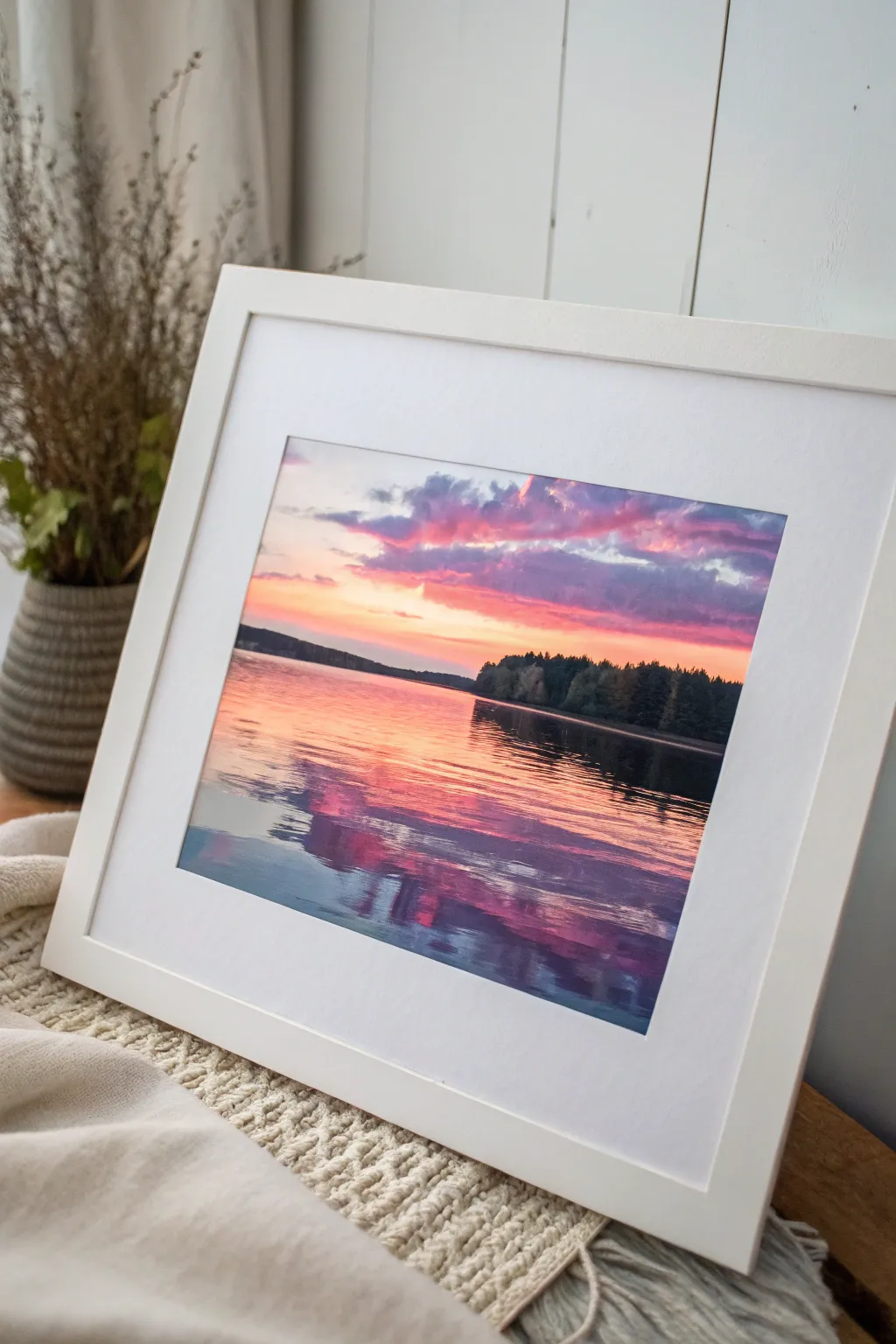 Watercolor sunset over a quiet lake, with soft ripples and a bold treeline silhouette.