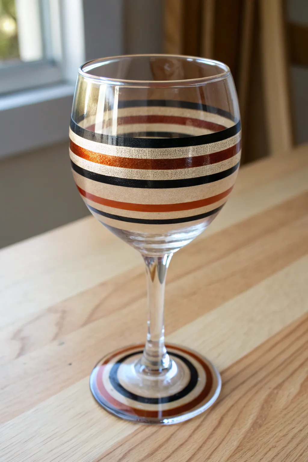 Crisp tape-guided stripes turn a simple wine glass into bold, beginner-friendly art.