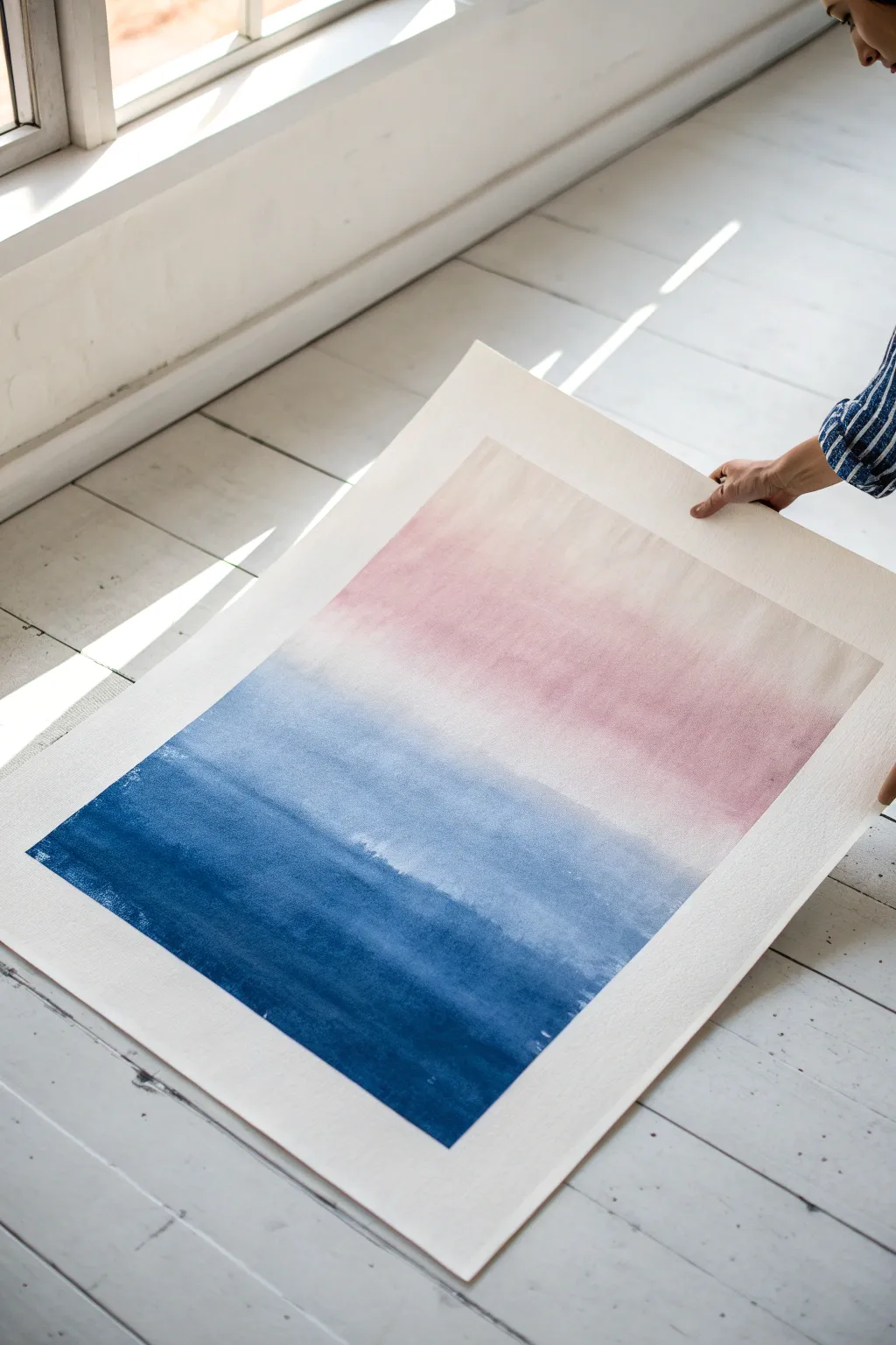 Dreamy ombre wash: deep indigo melting into pale blush on crisp white, minimalist and calming.