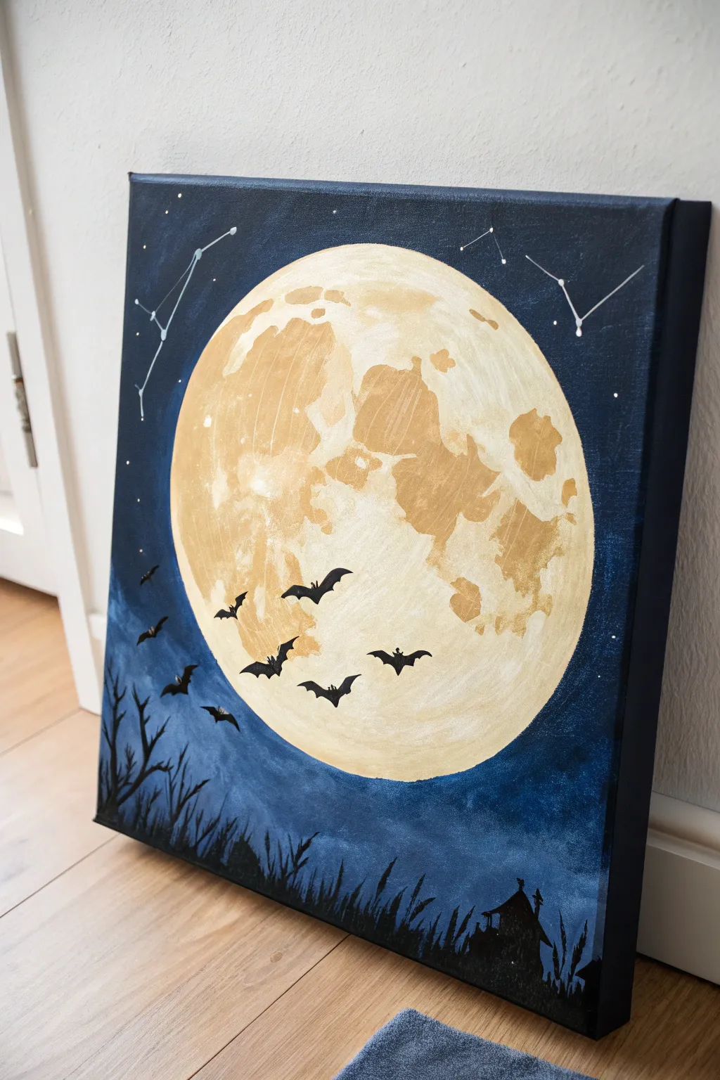 Textured full moon acrylic with bold bat silhouettes on deep blue for a chic Halloween vibe