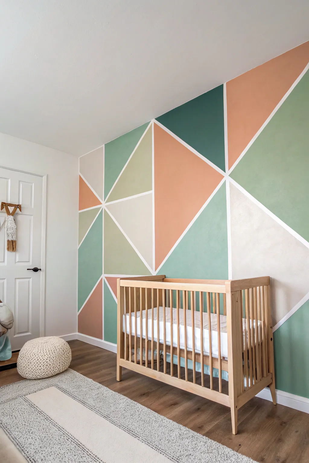 Muted geometric color-block mural for a modern nursery, crisp edges with sage, sand and clay.