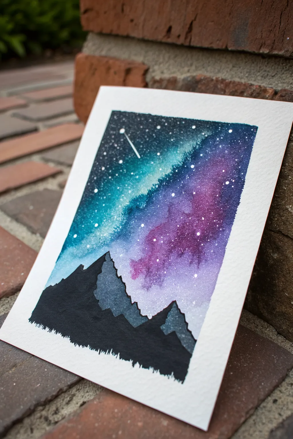 Beginner spray paint idea: bold galaxy sky above a crisp black mountain silhouette