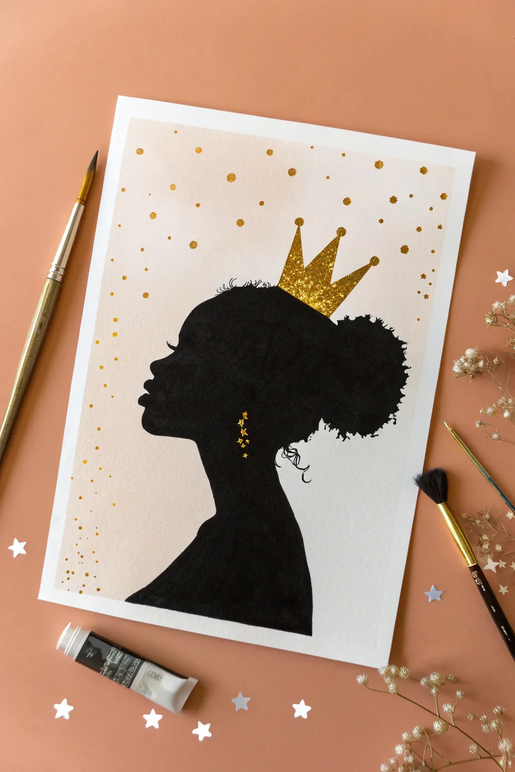 Paint a bold black silhouette with a simple gold crown on natural hair for an easy, chic look