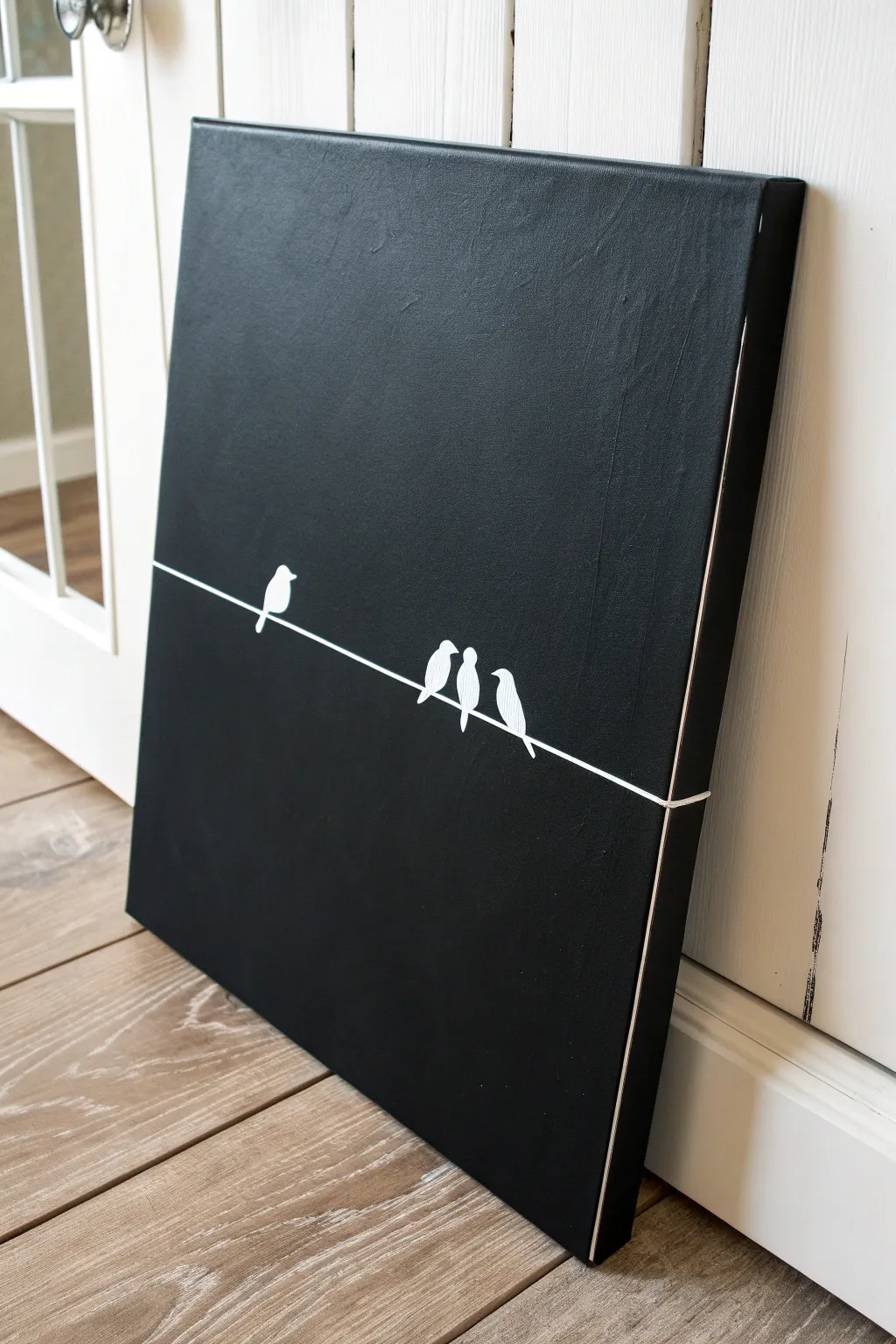 Minimal white-on-black birds on a wire painting idea for a chic Scandinavian boho space