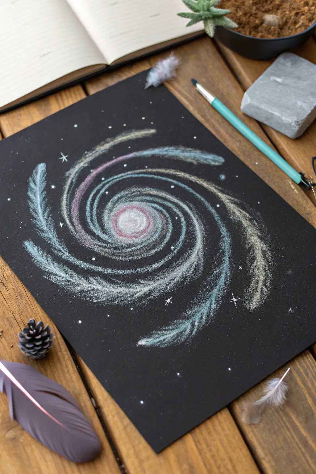 Soft-blended spiral galaxy on black paper, high-contrast whites with cool celestial glow