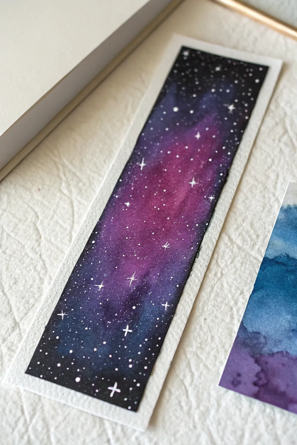 Paint your own universe with this dreamy watercolor galaxy bookmark idea for book lovers.