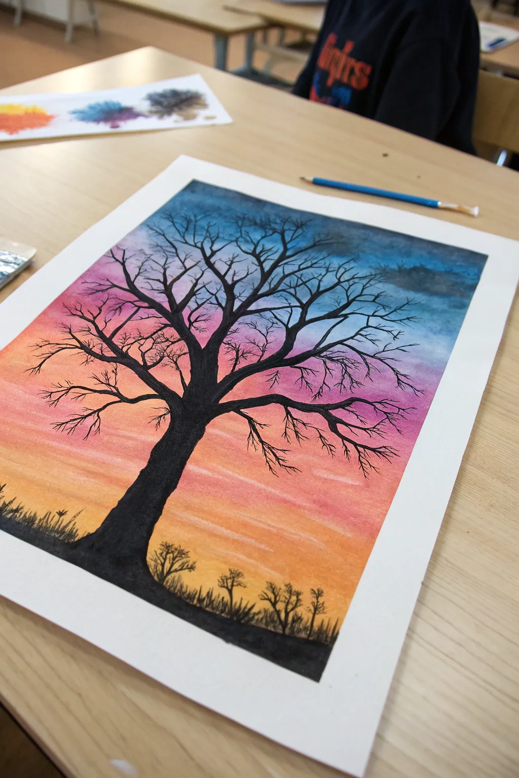 Bold black silhouette tree on a vibrant chalk pastel sunset sky, minimal and striking