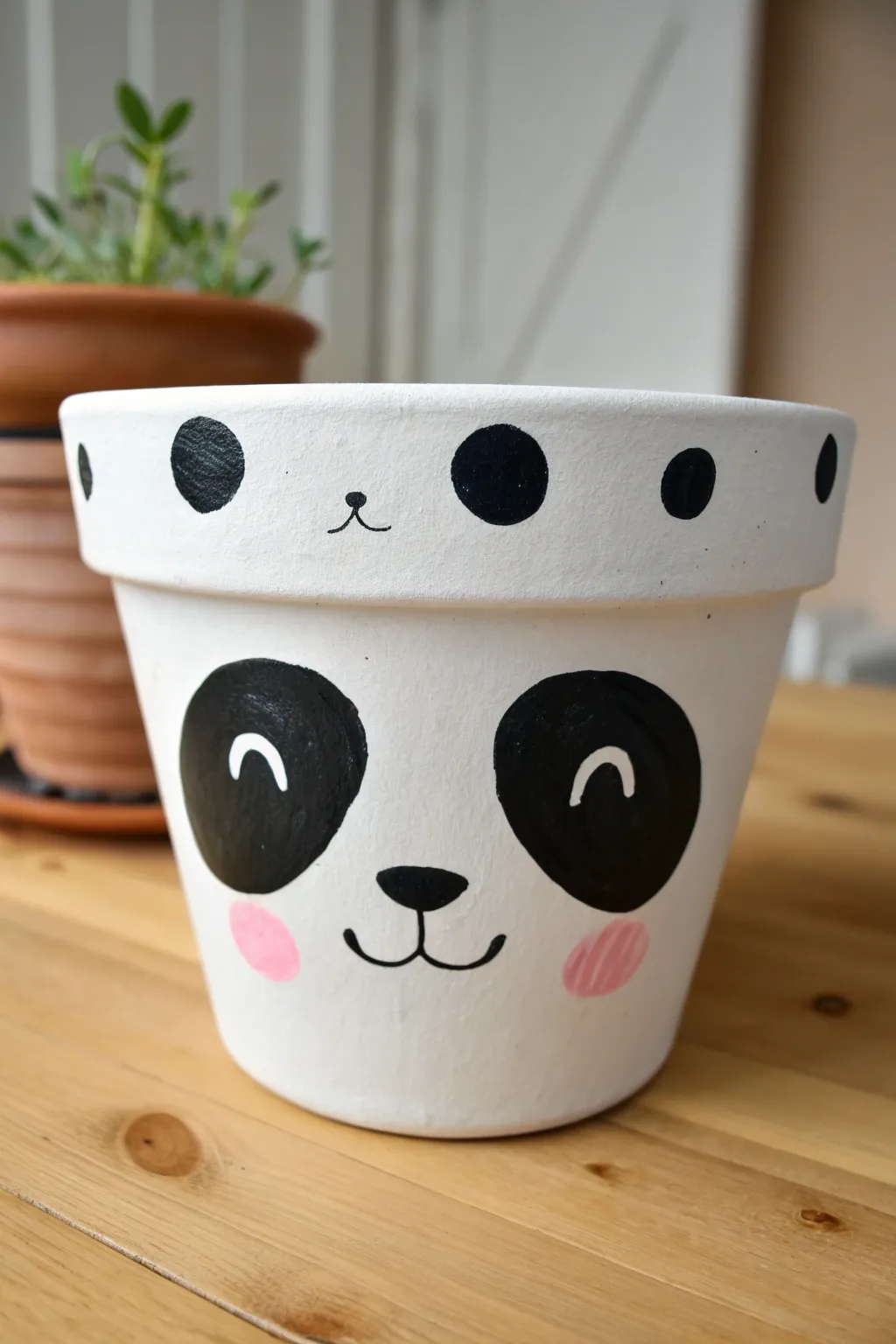 Minimal panda pot in bold black and white with tiny blush dots, perfect for cute pot painting