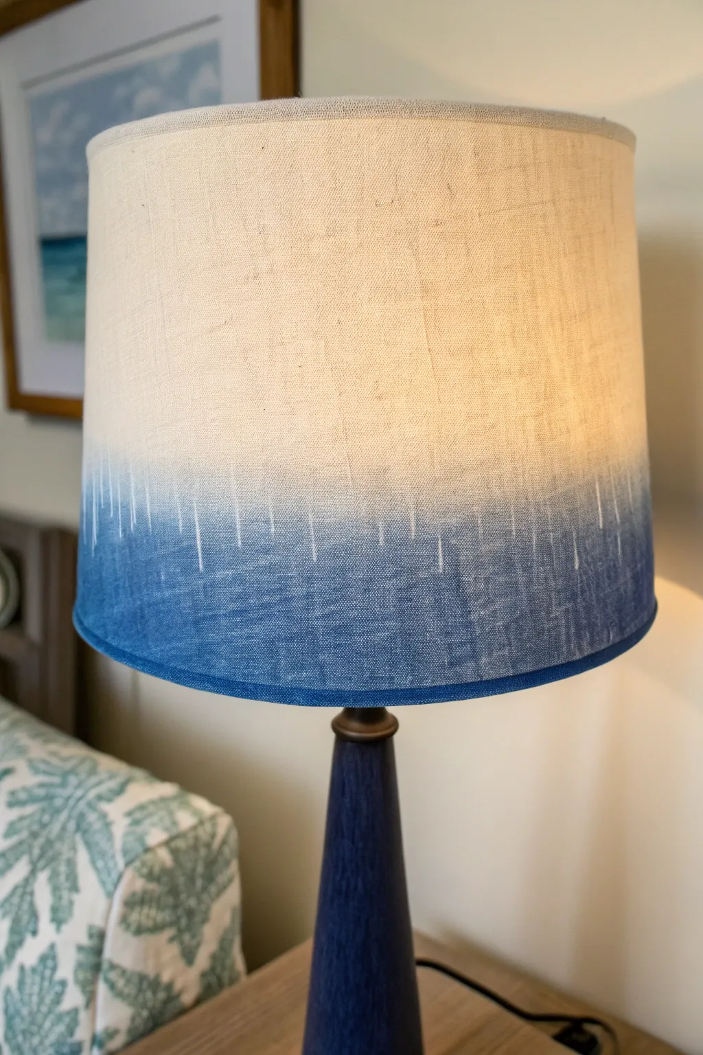 Soft ombre painted lampshade glowing warmly, minimalist boho craft inspo for your next DIY.