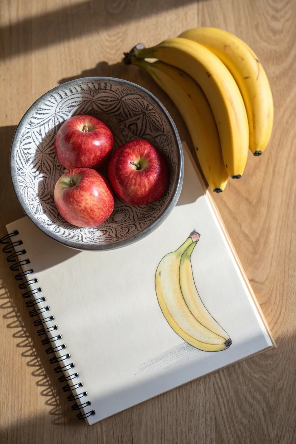 Simple fruit bowl still life with bright highlights and deep shadows, perfect for age 12 sketching