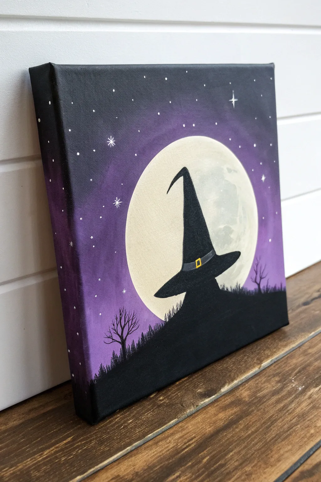 Minimal witch hat silhouette against a glowing moon, an easy Halloween canvas painting idea