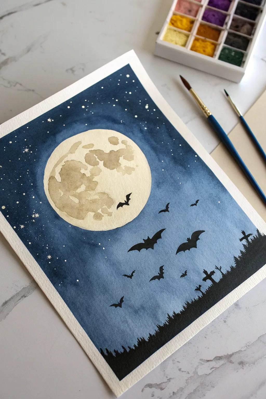 Easy Halloween paint idea: bold bat silhouettes sweeping across a glowing full moon.
