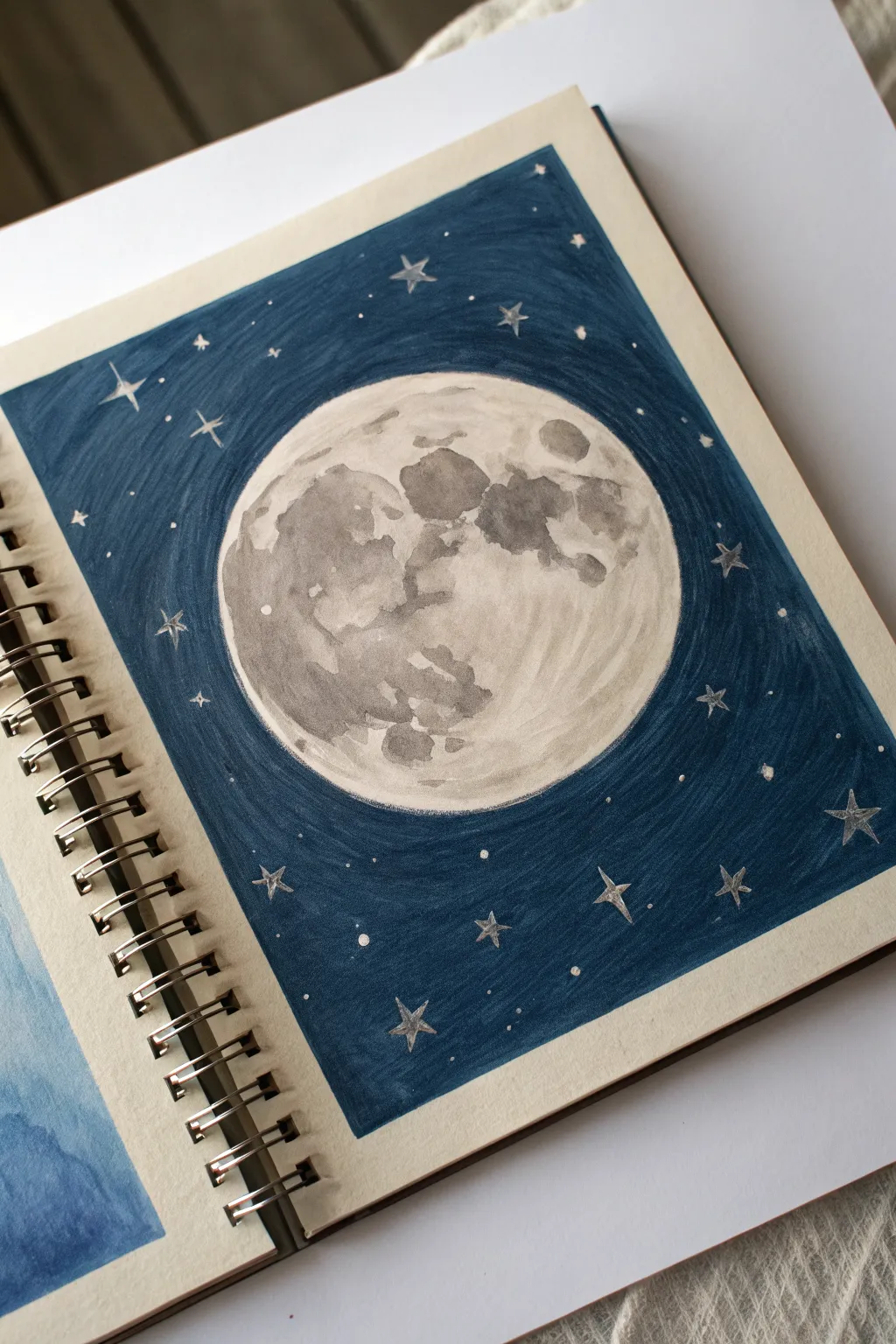 Easy colored pencil idea: big shaded moon and tiny stars on a deep, layered night sky.