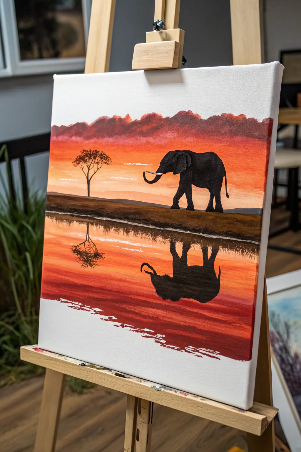 Minimalist elephant silhouette at sunset, mirrored in calm water, perfect acrylic inspiration