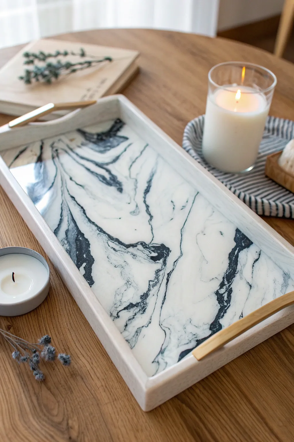 Glossy marble swirl epoxy tray with bold veining, styled minimal on light oak for contrast