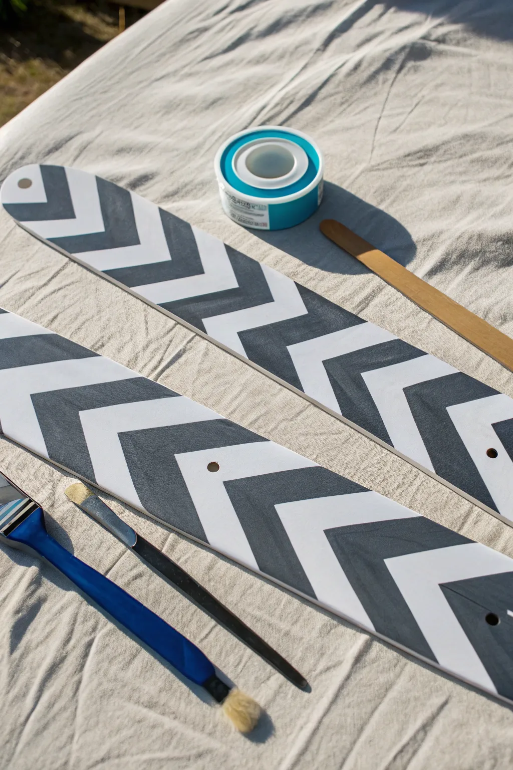 Give your ceiling fan a stunning glow-up with this modern geometric chevron paint idea.