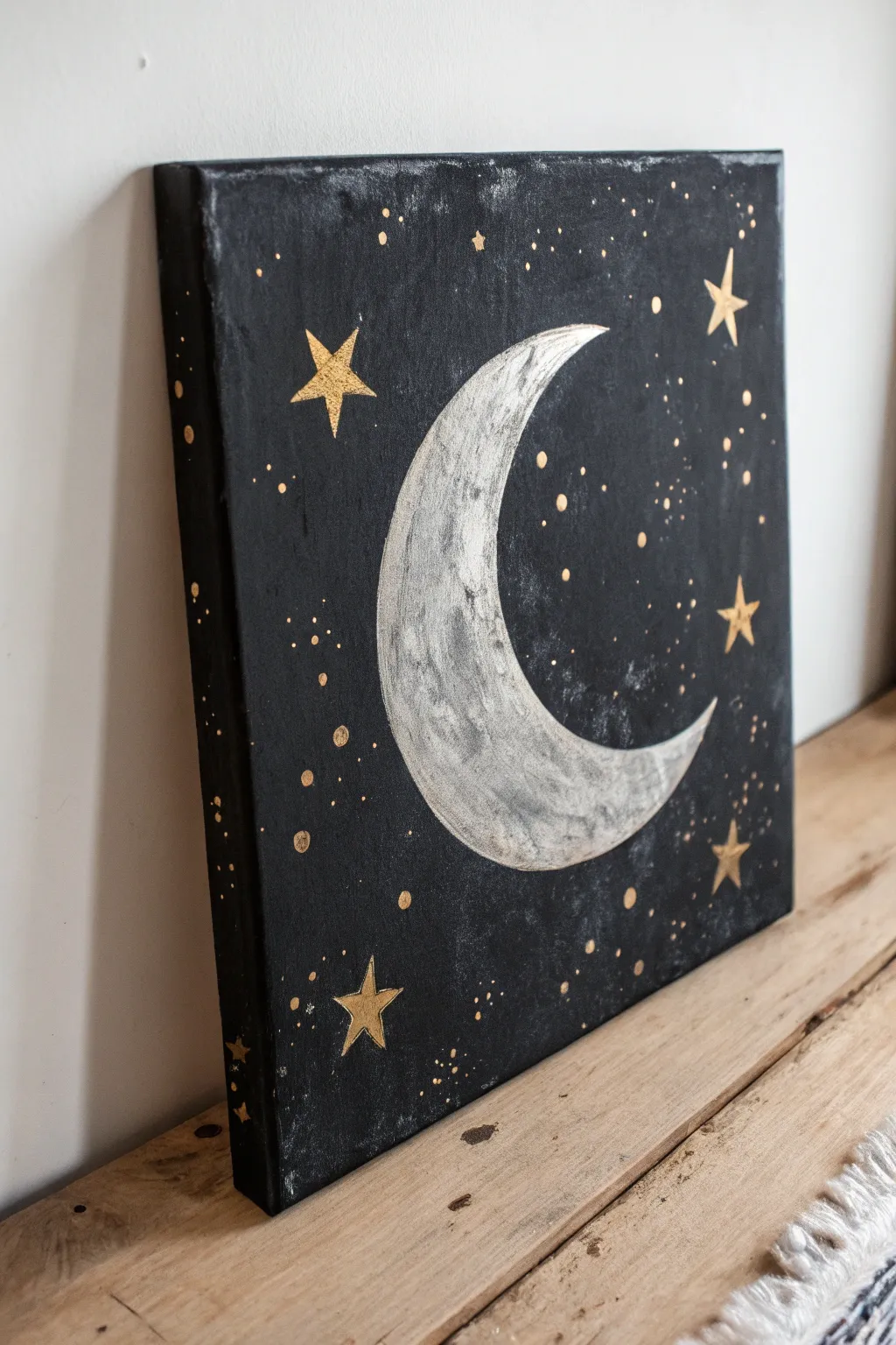 Grunge moon and stars on deep black, high contrast with soft worn smudges and bold minimal charm