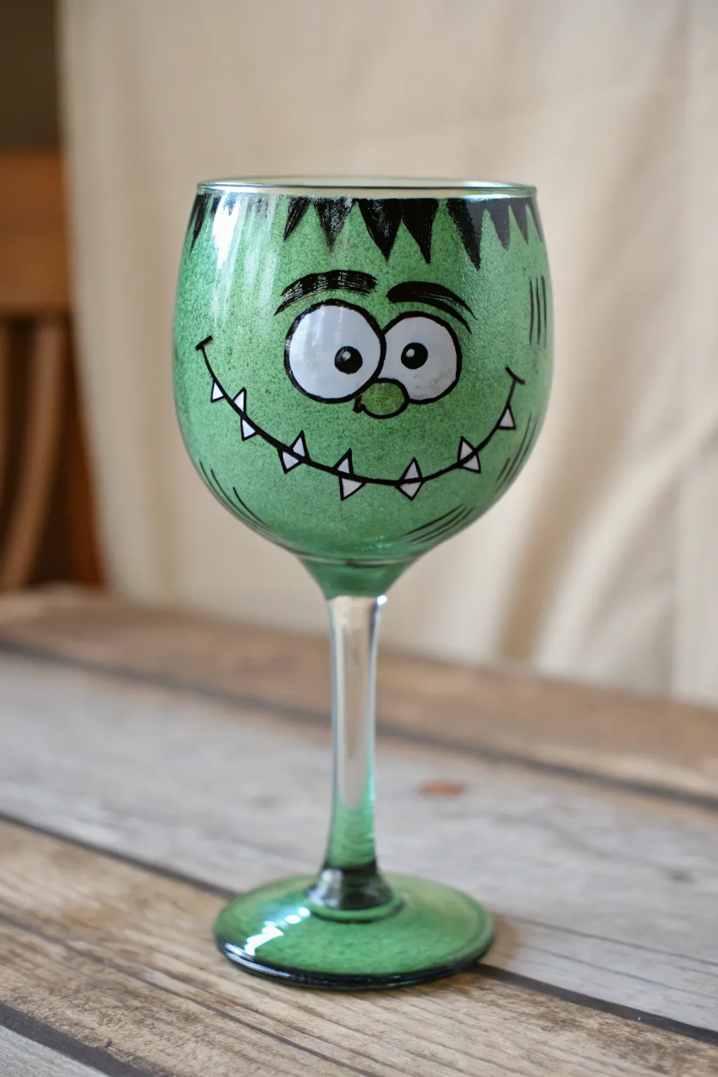 Stitched green monster face glass painting with bold contrast for minimalist Halloween decor