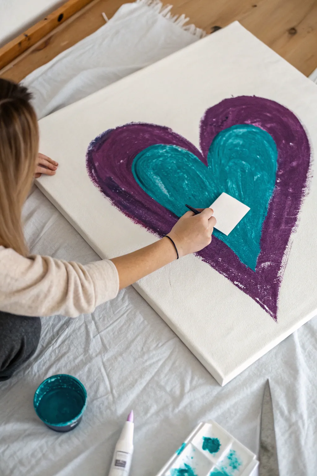 Create stunning textured heart art easily using thick acrylics and an old plastic card.
