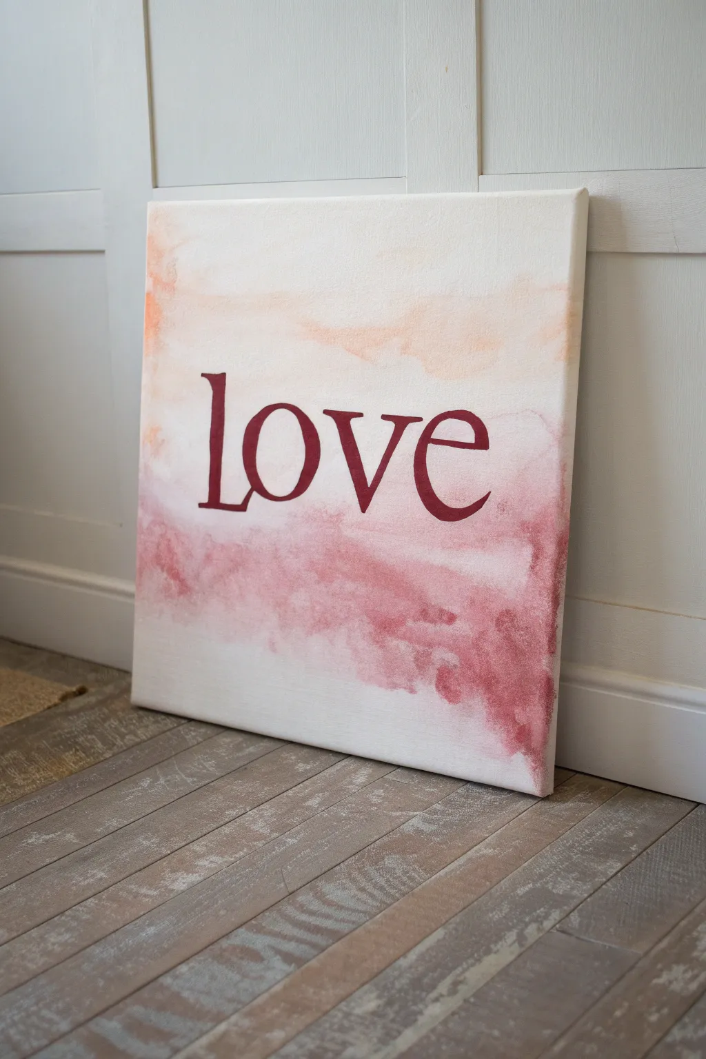 Hand-lettered LOVE on a blush watercolor wash, minimalist yet bold romantic canvas art