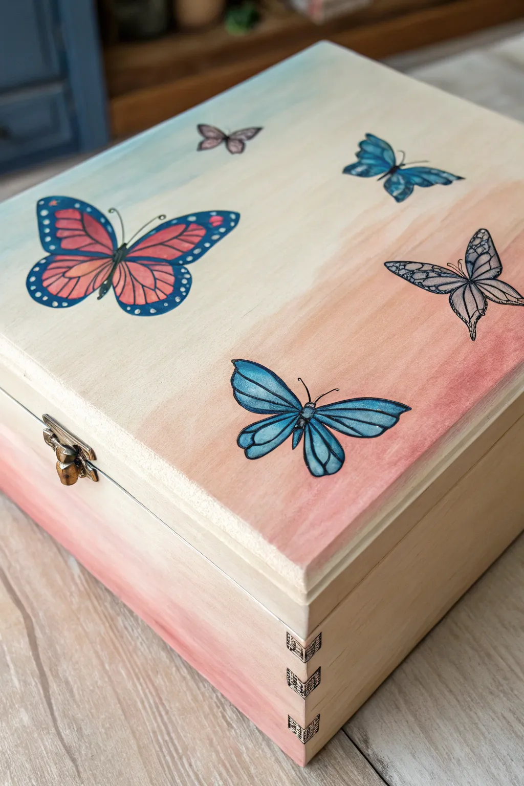 Minimal memory box lid with bold painted butterflies drifting across a soft gradient backdrop