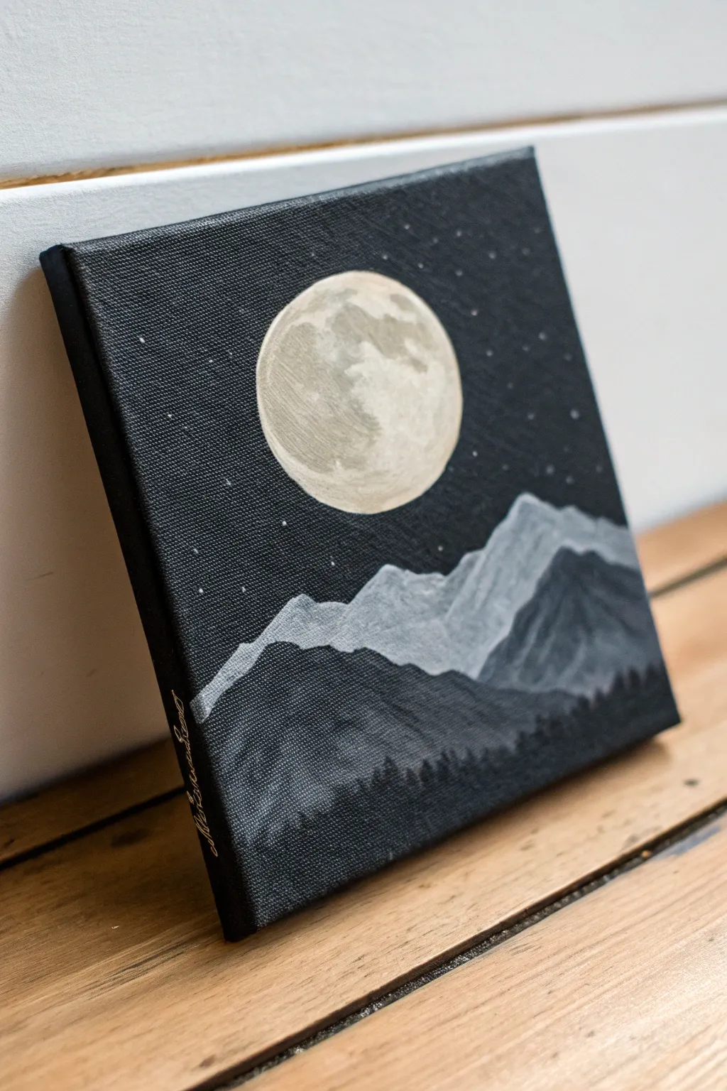 Mini black canvas nightscape: pale moon, layered mountains, and one simple moonlit ridge line