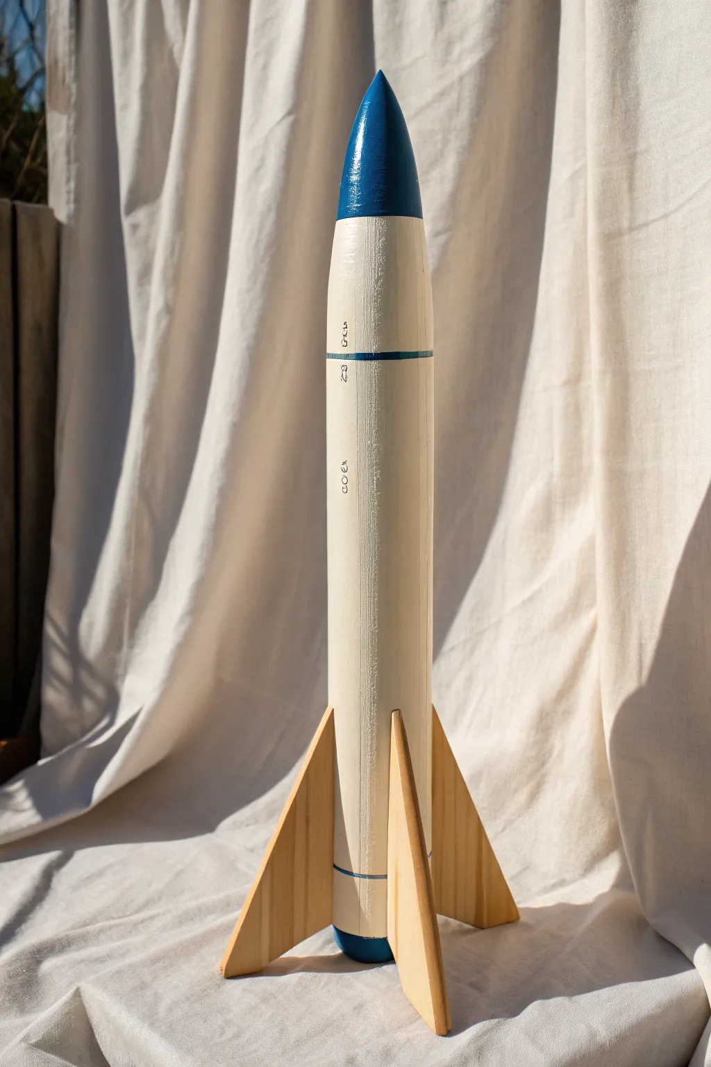Pop-color nose cone accent turns a neutral model rocket into a bold, modern statement piece.