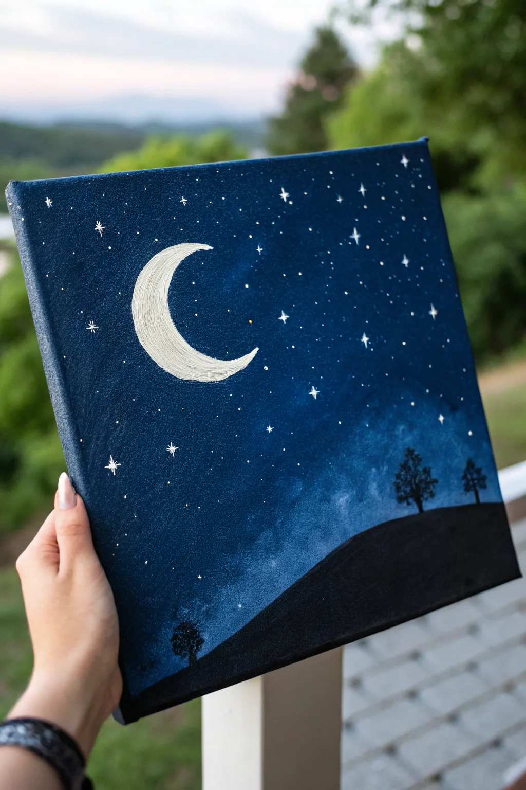 Minimal crescent moon over indigo sky, a few stars and a quiet hill silhouette