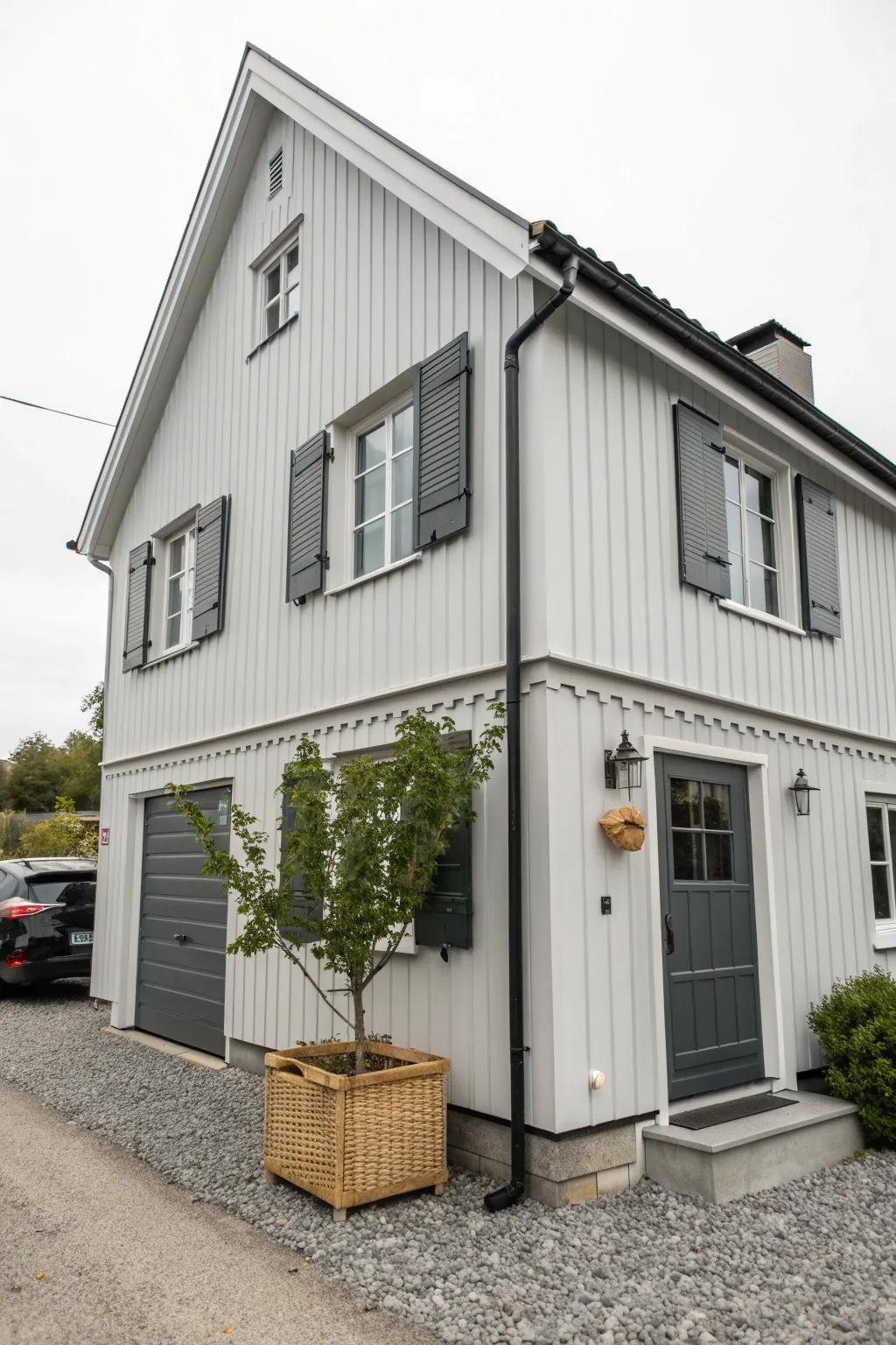Light gray siding and charcoal shutters create crisp modern contrast for outdoor paint inspiration.