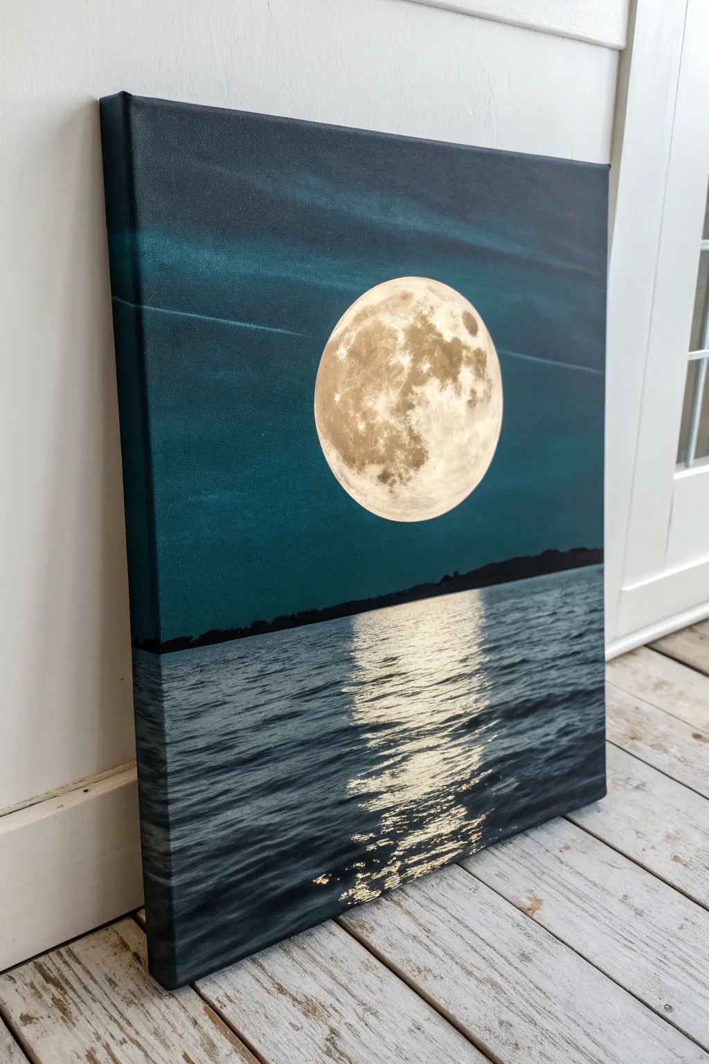 Paint-and-sip calm: a big moon and simple reflection over a dark, glassy lake