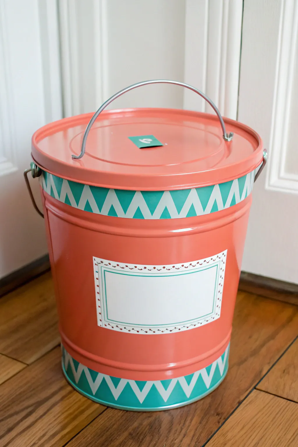 Bright lidded toy bucket DIY with a crisp stenciled label panel for a chic playroom corner