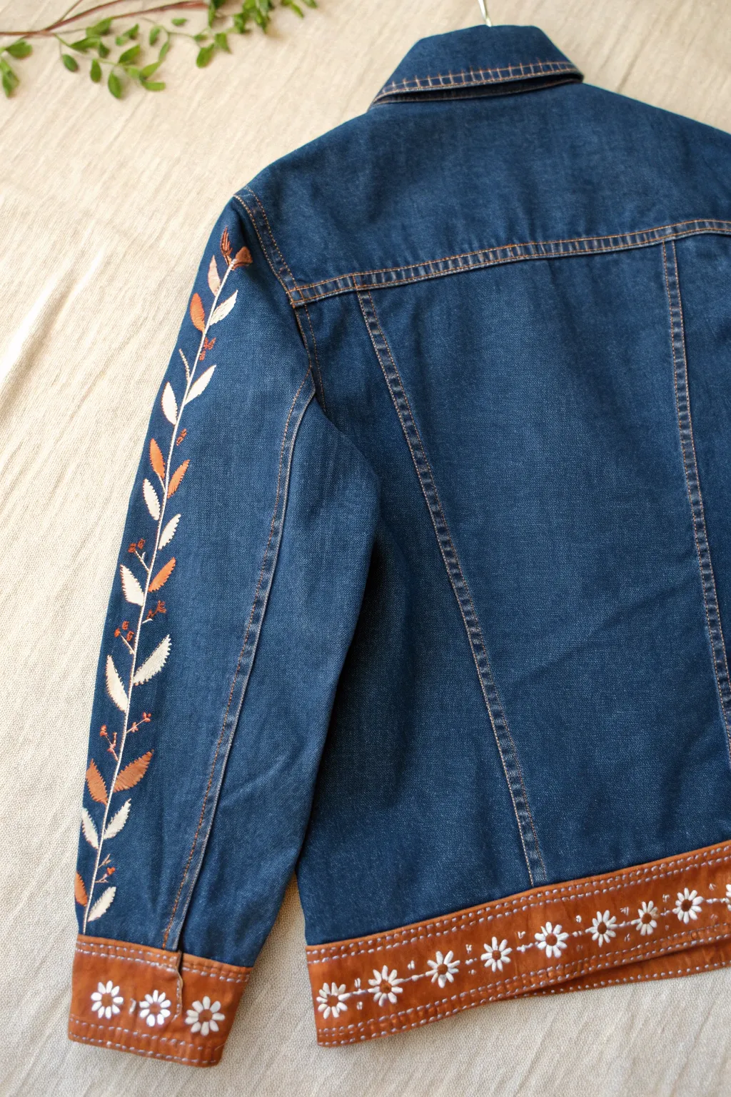 Painted trim on denim: tiny dots and vines that make collars and cuffs pop instantly