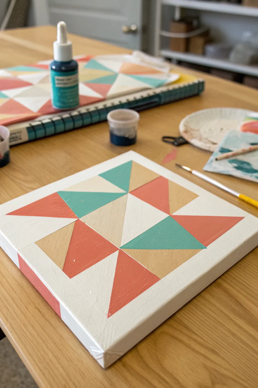 Geometric tape-resist abstract in coral and teal, mid-peel reveal for crisp bold contrast