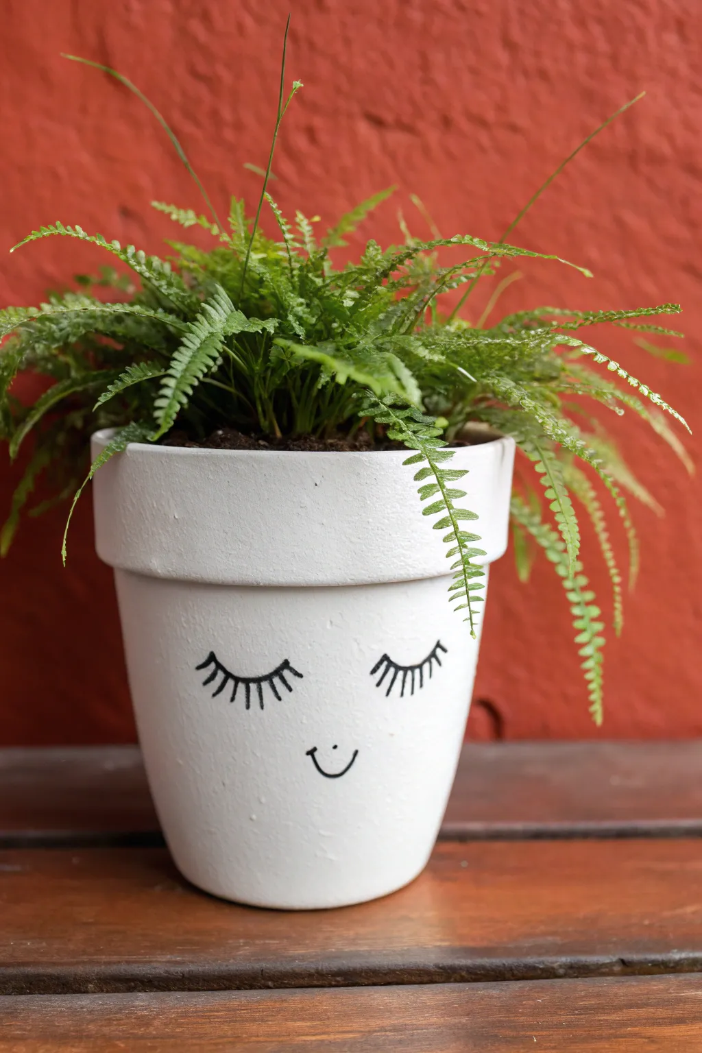 Elevate your plant shelf with this charming minimalist boho face pot painting idea.