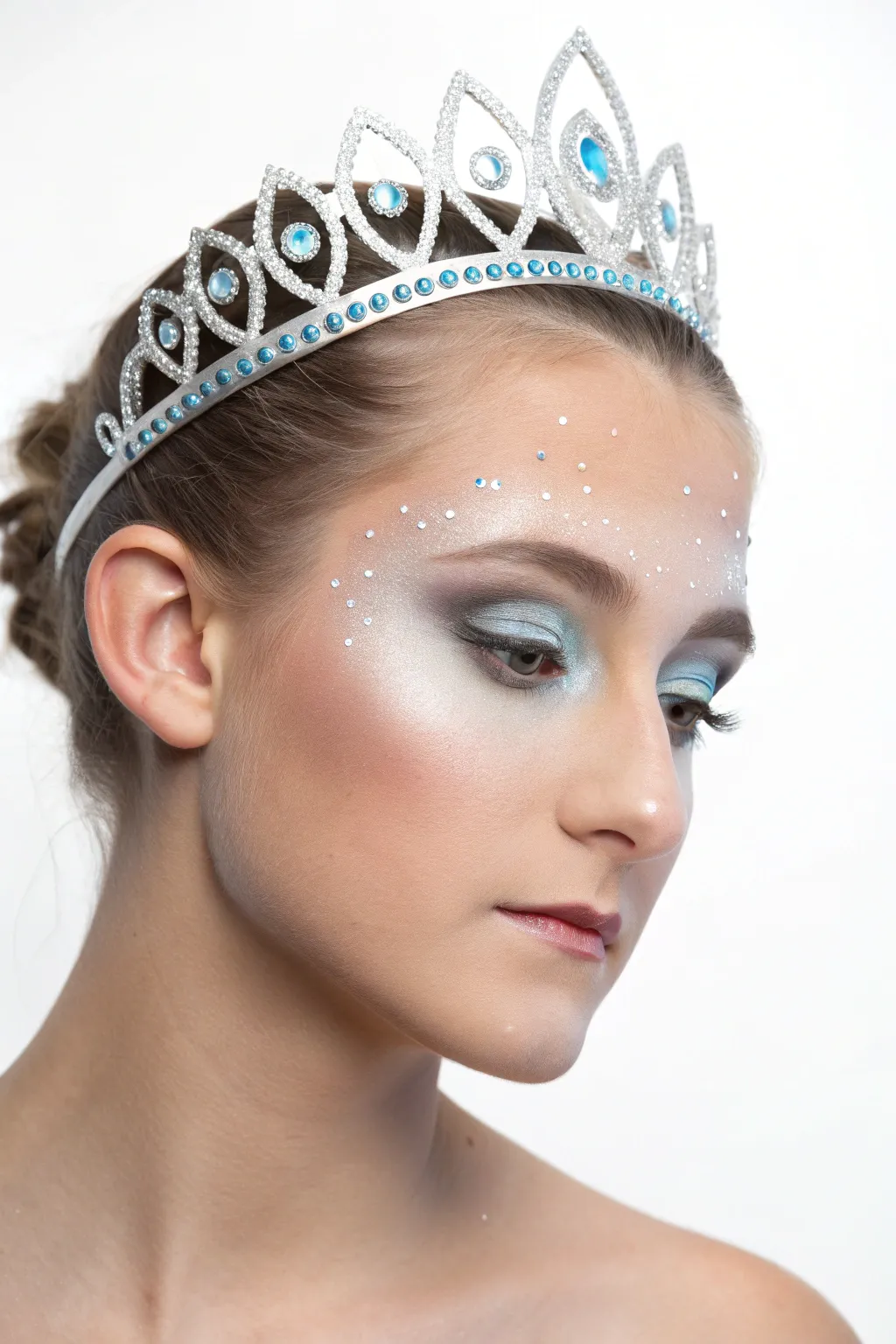 Silver ice princess tiara face paint in cool blues, frosty highlights, and delicate sparkles