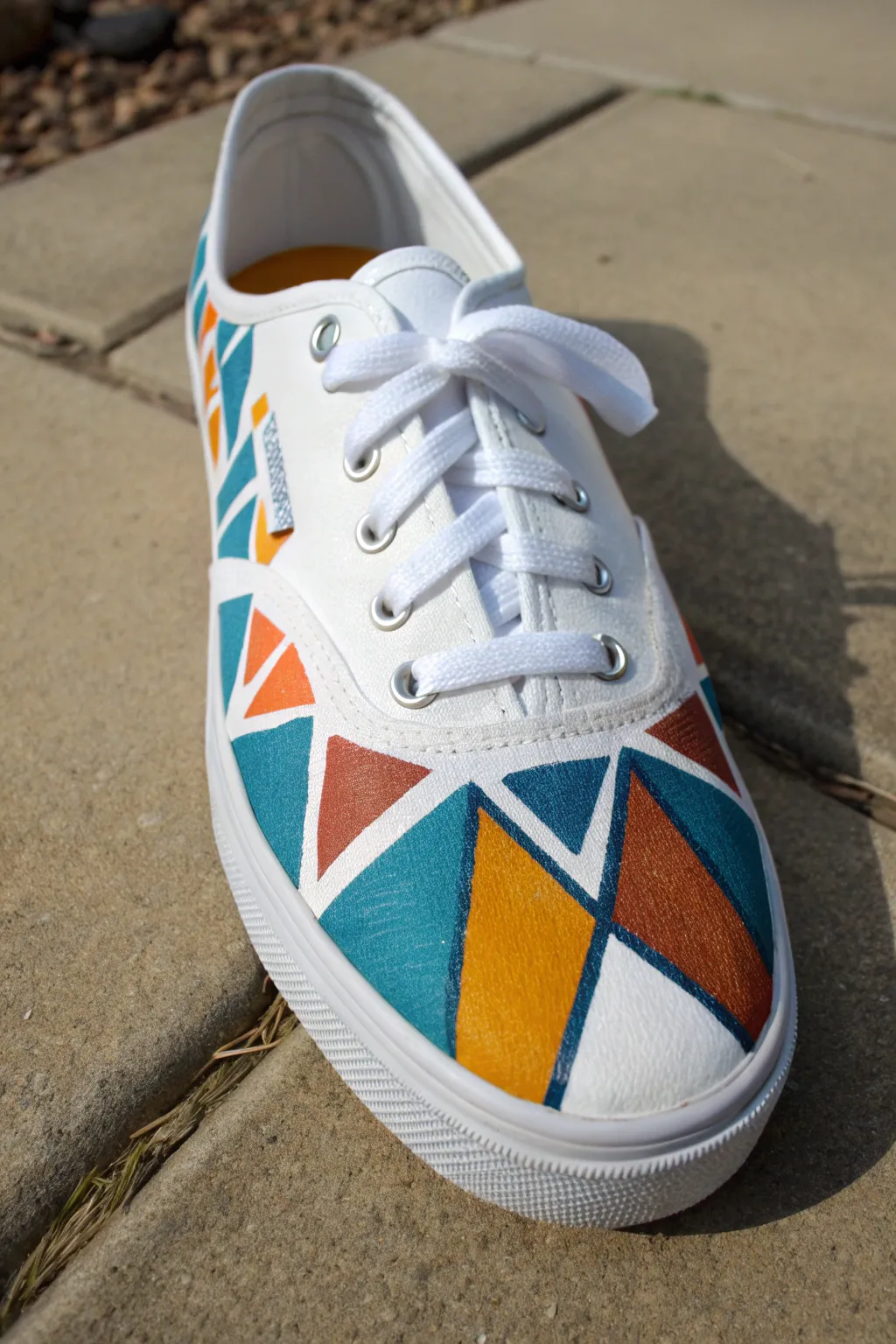 Crisp tape lines and bold geometric color blocks turn a simple sneaker into modern shoe art.