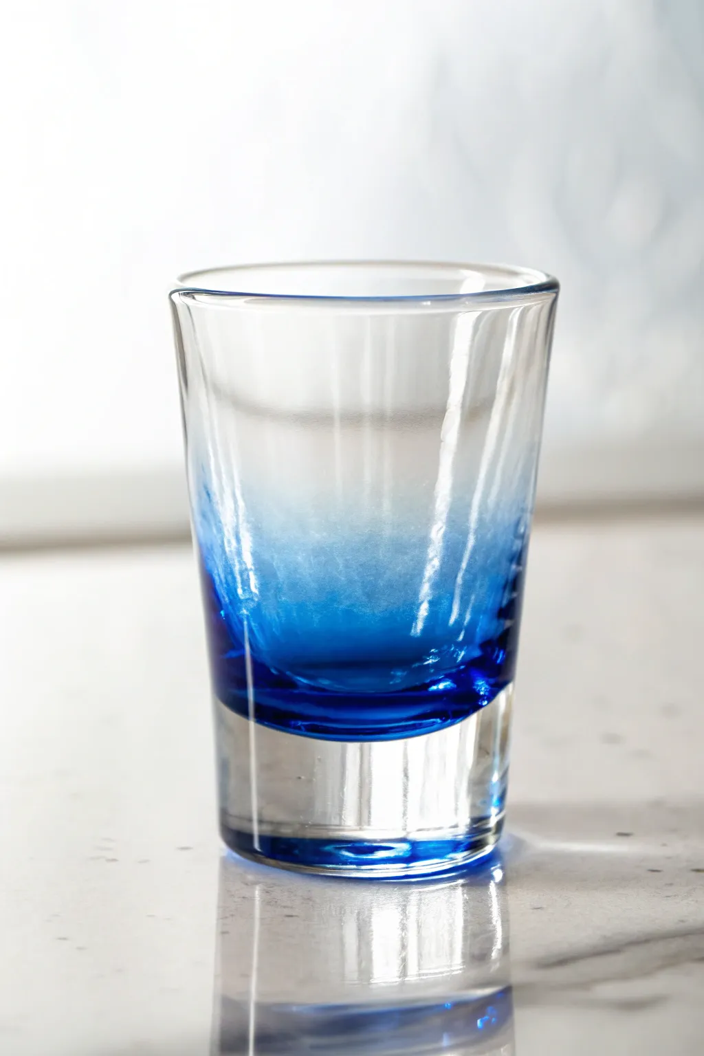 Bottom-up ombre shot glass paint idea: bold cobalt base fading into clear minimal glass