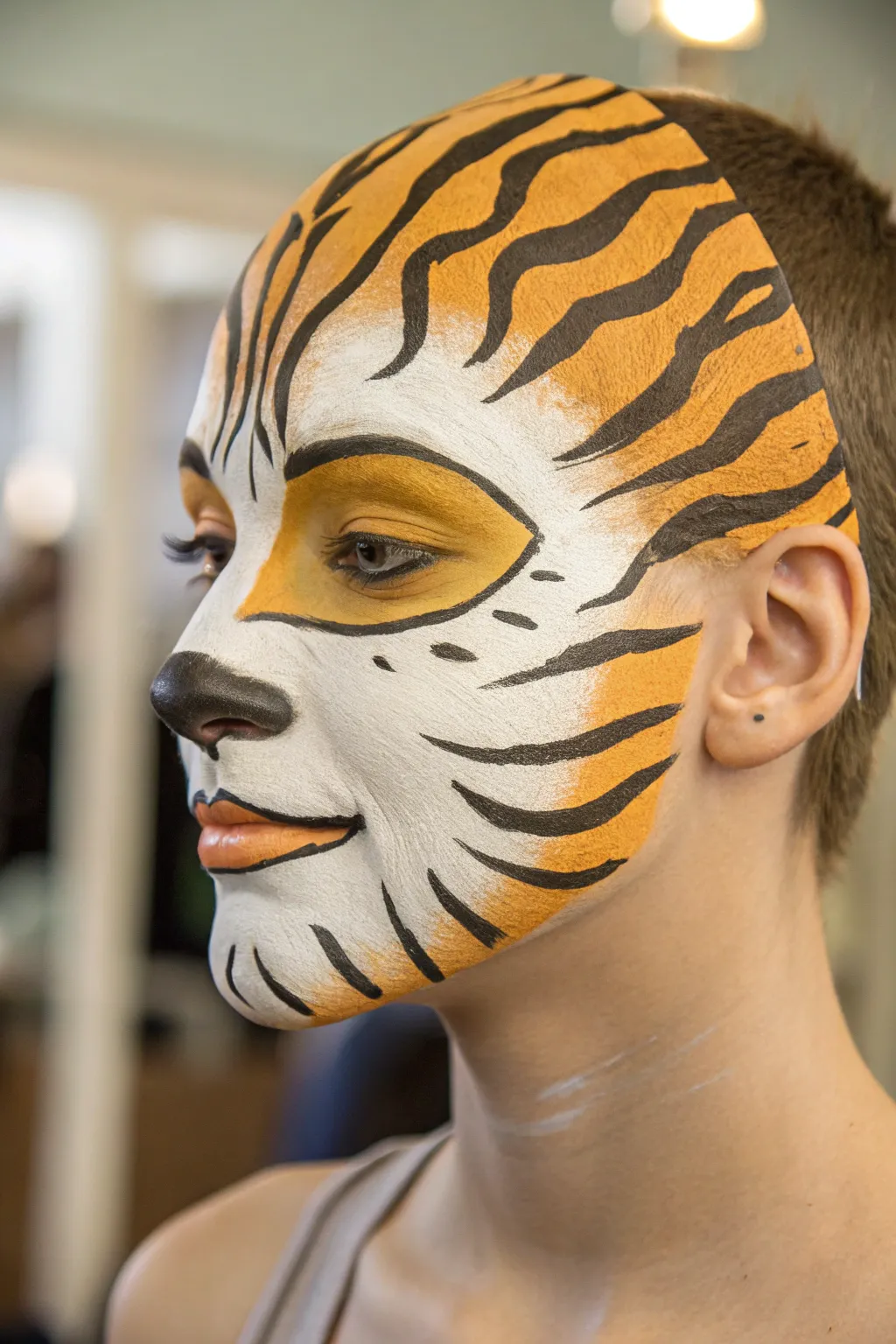 Beginner tiger face paint: bold stripes and a clean white muzzle with high-contrast detail