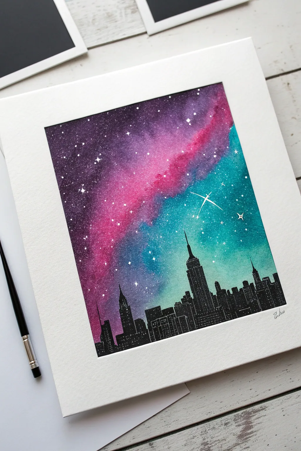 Crisp black skyline stencil against a glowing nebula spray paint backdrop with sharp masked details.